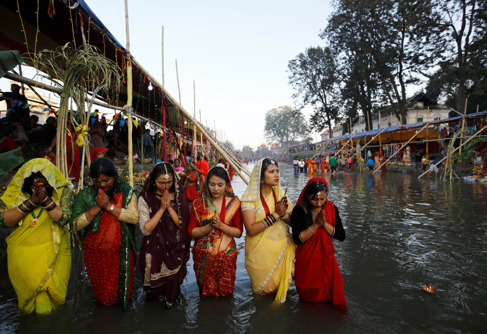 Devotees offer prayers to the setting sun during the “Chhat” festival