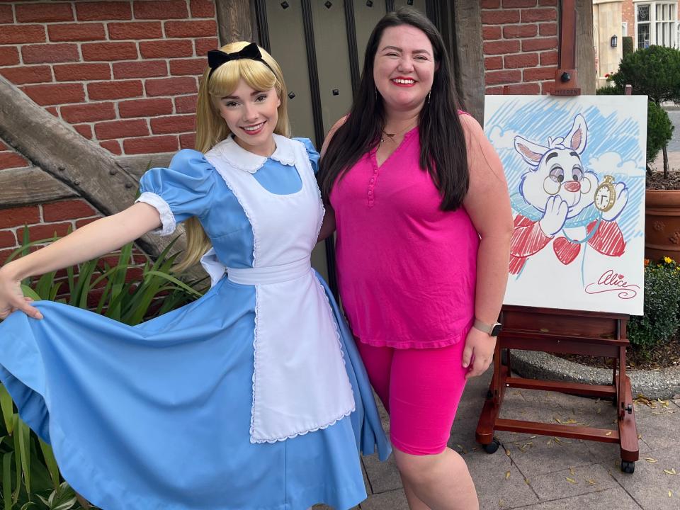 megan posing with alice at epcot as an adult