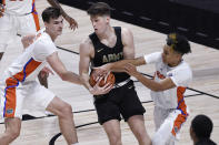 Army's Nick Finke, center, is pressured by Florida's Colin Castleton, left, and Tre Mann, right, in the first half of an NCAA college basketball game, Wednesday, Dec. 2, 2020, in Uncasville, Conn. (AP Photo/Jessica Hill)