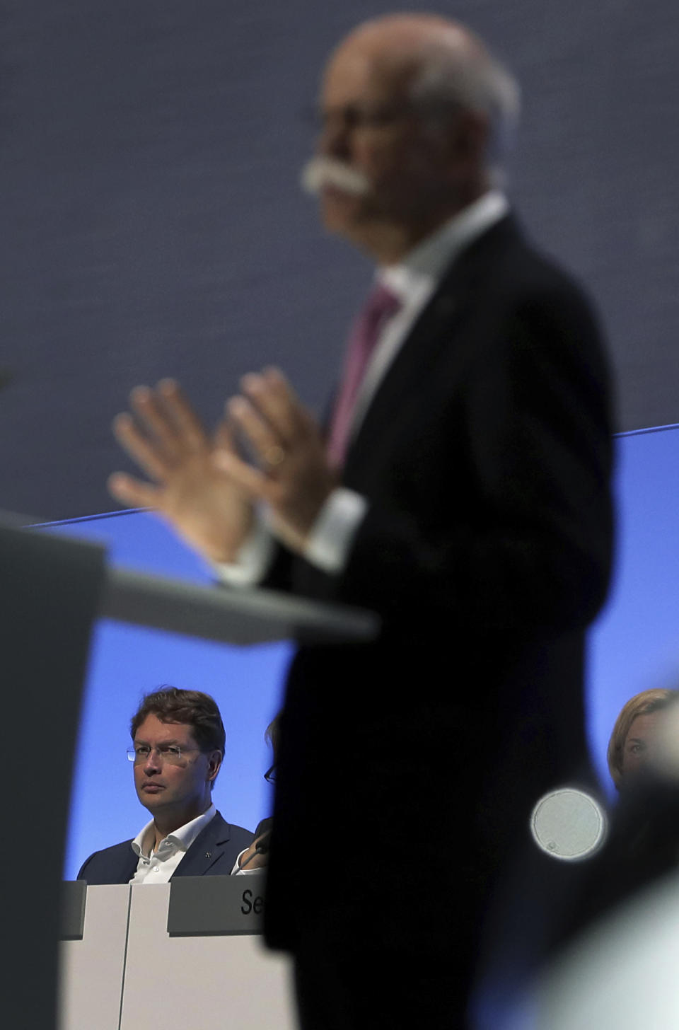 Incoming Daimler CEO Ola Kaellenius, rear, attends the speech of Daimler CEO Dieter Zetsche, right, during the annual shareholder meeting of the car manufacturer Daimler in Berlin, Germany, Wednesday, May 22, 2019. (AP Photo/Michael Sohn)