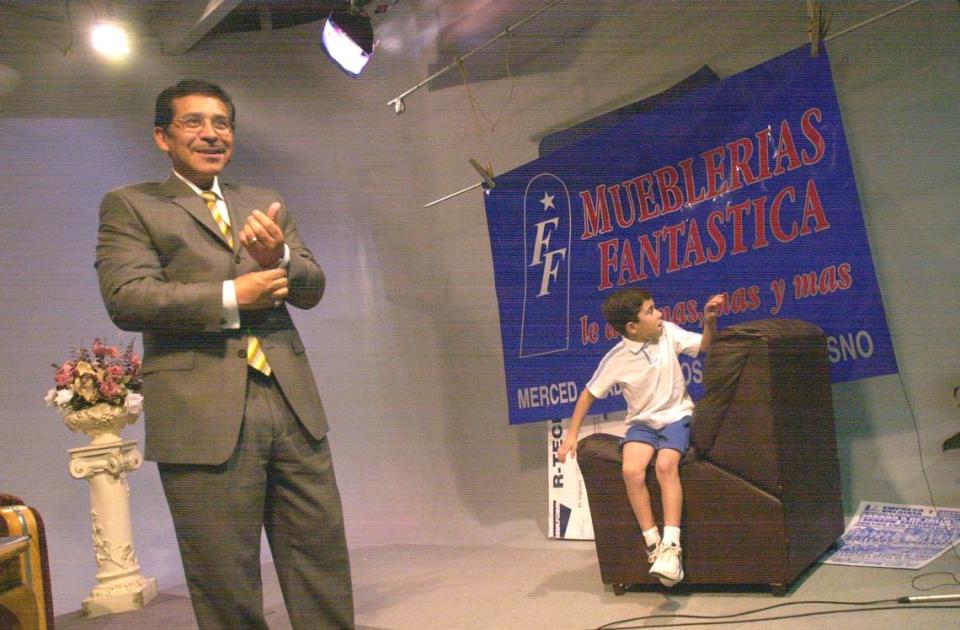Gil García Padrón and family tape the last episode of his weekend television program in July 2003. His son, Gil Jr., looks on.