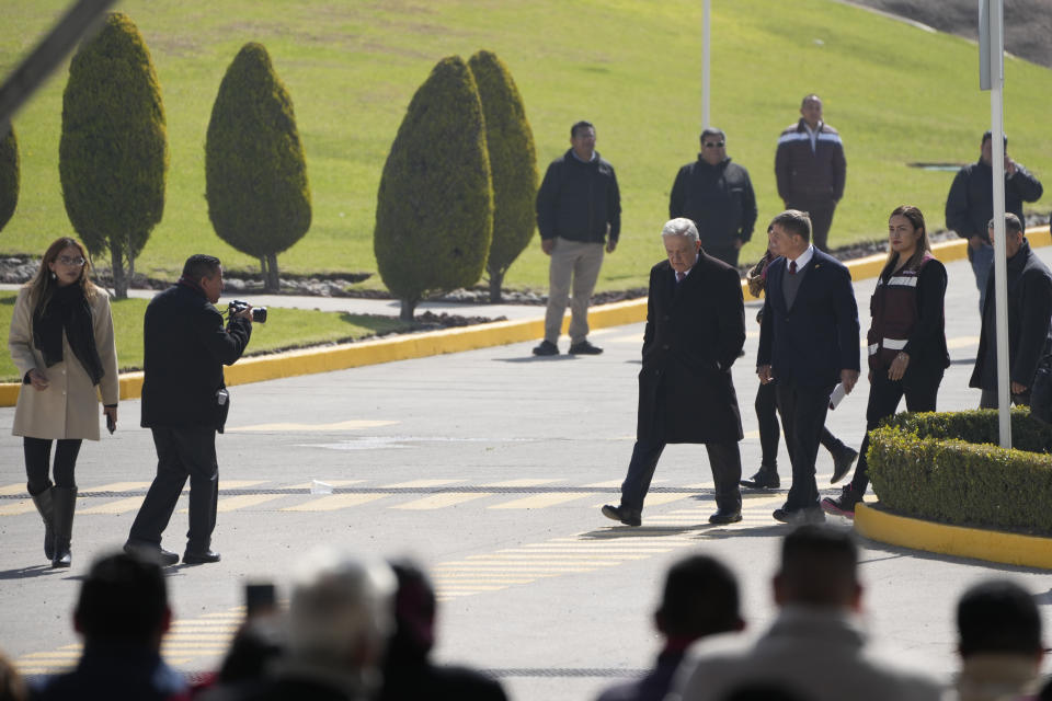 Mexican President Andrés Manuel López Obrador, center right, arrives to a ceremony to inaugurate a "mega-pharmacy" warehouse in Huehuetoca, Mexico, Friday, Dec. 29, 2023. It is the president's solution to help end a supply issue for hospitals that don't have specific medicines needed by patients. (AP Photo/Fernando Llano)