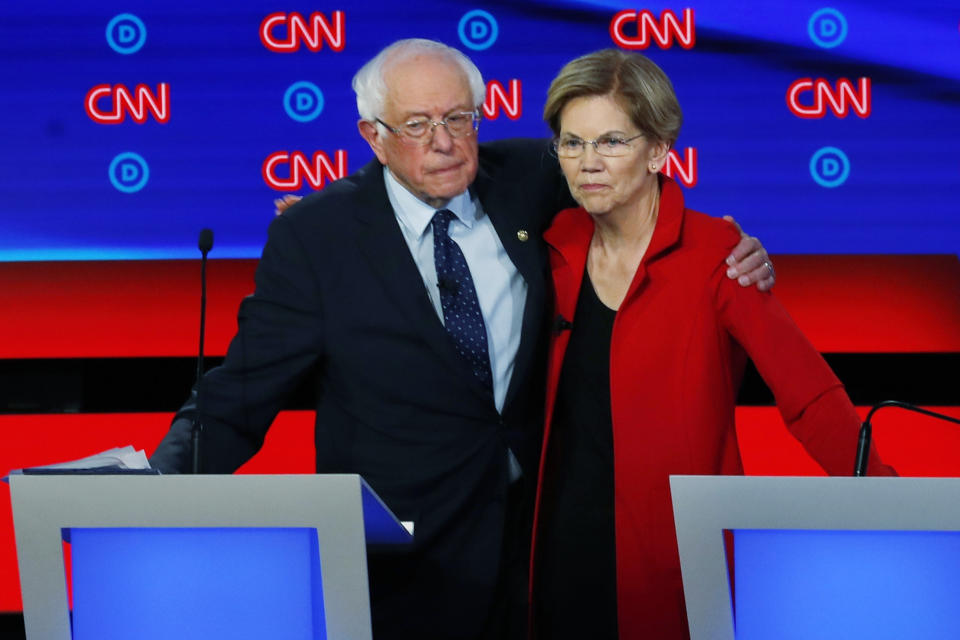 FILE - In this July 30, 2019 file photo, Sen. Bernie Sanders, I-Vt., and Sen. Elizabeth Warren, D-Mass., embrace after the first of two Democratic presidential primary debates hosted by CNN in the Fox Theatre in Detroit. (AP Photo/Paul Sancya)