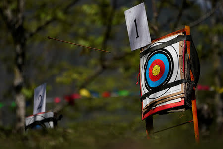 An arrow flies towards the target board during a crossbow shooting competition in Luzhang township of Nujiang Lisu Autonomous Prefecture in Yunnan province, China, March 29, 2018. REUTERS/Aly Song