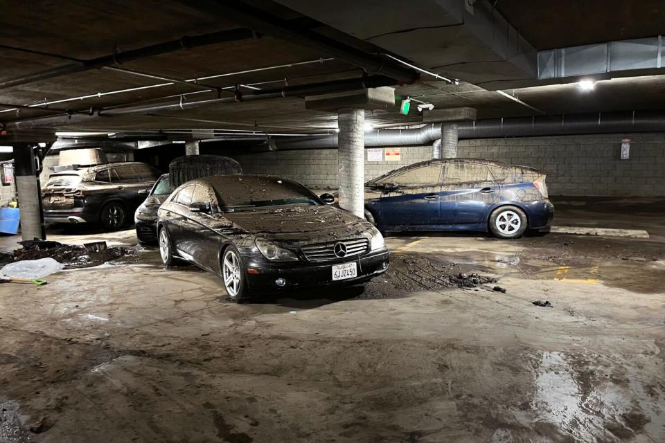 Damaged cars parked on a subterranean level of a Hancock Park condo building's garage.