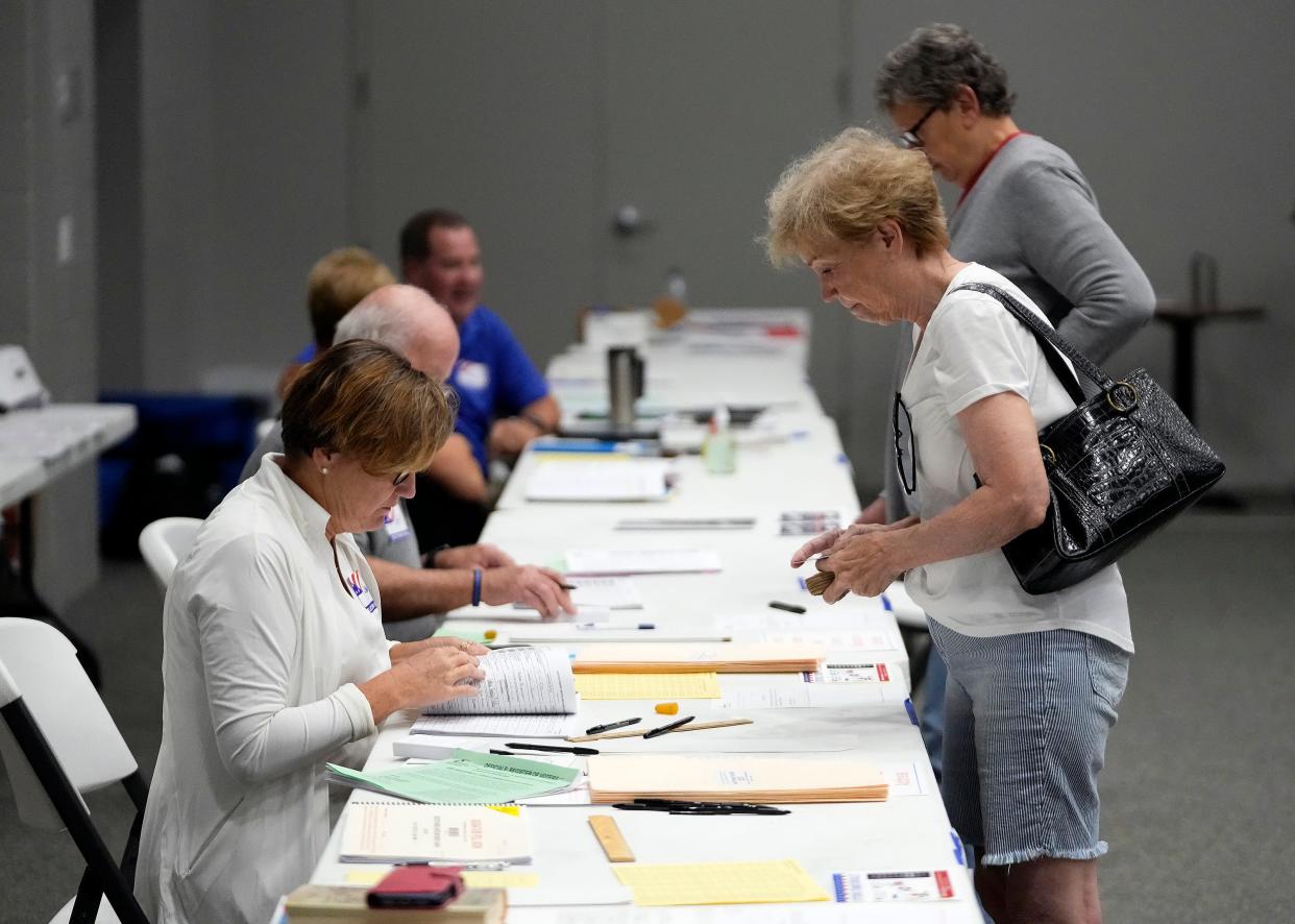 Roxanne Mackei of Columbus checks in to vote at United Methodist Church in Hilliard during Tuesday's primary election.