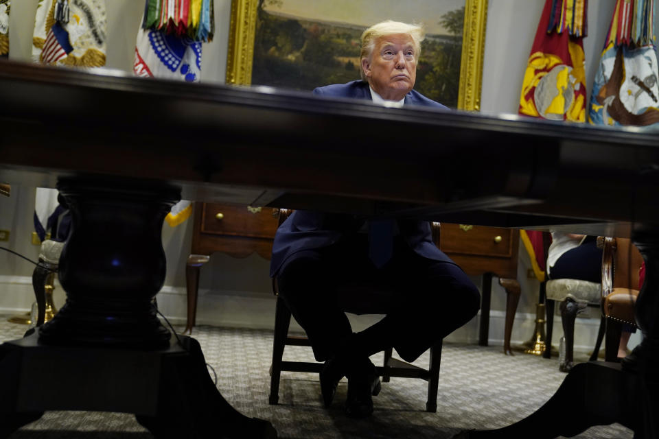 President Donald Trump listens during a conference call with banks on efforts to help small businesses during the coronavirus pandemic, at the White House, Tuesday, April 7, 2020, in Washington. (AP Photo/Evan Vucci)