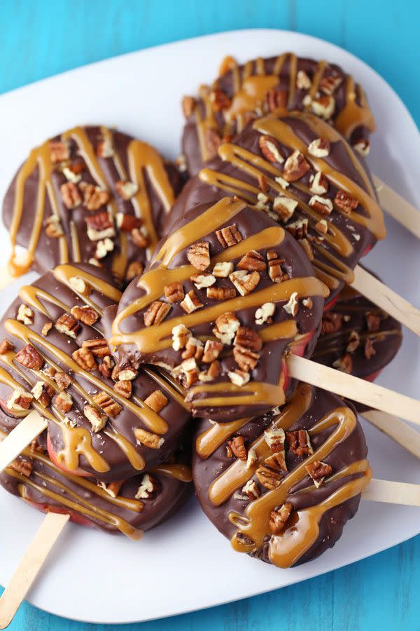 <p>Serving these chocolate-covered apple slices on a stick is the perfect way for party guests to enjoy them, mess-free. </p><p><strong>Get the recipe at <a href="http://www.momlovesbaking.com/chocolate-turtle-apple-slices/" rel="nofollow noopener" target="_blank" data-ylk="slk:Mom Loves Baking;elm:context_link;itc:0;sec:content-canvas" class="link ">Mom Loves Baking</a>. </strong></p><p><a class="link " href="https://www.amazon.com/Perfect-Stix-Wooden-Sticks-Length/dp/B009EE2TVQ/?tag=syn-yahoo-20&ascsubtag=%5Bartid%7C10050.g.454%5Bsrc%7Cyahoo-us" rel="nofollow noopener" target="_blank" data-ylk="slk:SHOP ICE CREAM STICKS;elm:context_link;itc:0;sec:content-canvas">SHOP ICE CREAM STICKS</a> </p>