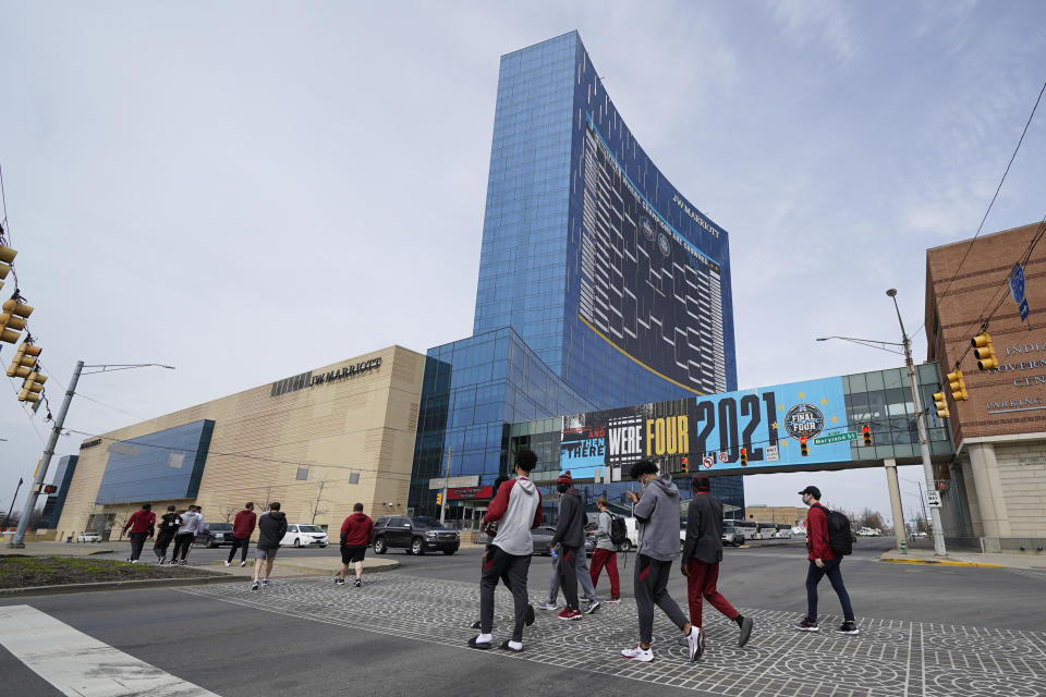 The Arkansas basketball team walks to Victory Field for the NCAA college basketball tournament, Wednesday, March 17, 2021, in Indianapolis. (AP Photo/Darron Cummings)