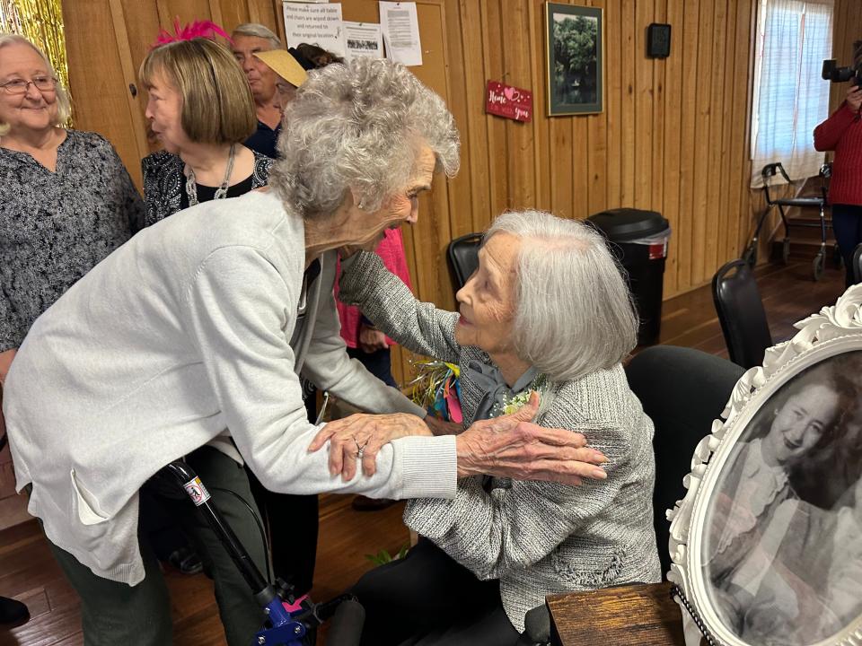 Merle Jones, 91, speaks to Era Herring Luckie Daniell and gives her a hug at the birthday celebration. The two have known each other more than 50 years.