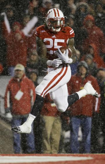 Wisconsin&#39;s Melvin Gordon scores on a 26-yard touchdown in the third quarter of an NCAA college football game against Nebraska Saturday, Nov. 15, 2014, in Madison, Wis. Gordon ran for 408 yards through three quarters Saturday, capping it off with this run to break the single-game major college football rushing record set on Nov. 20, 1999, when LaDanian Tomlinson with 406 yards on 43 carries for TCU against UTEP. (AP Photo/Morry Gash)