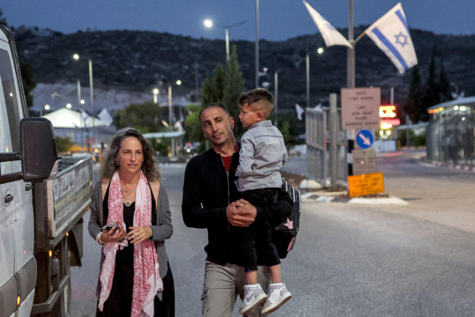 Adam Abu al-Rob, a six-year-old Palestinian eye cancer patient, is carried by his father Mamoun as they meet with Road to Recovery volunteer Yael Noy at the Rehan checkpoint between Israel and the occupied West Bank, driven by her on their way from the Palestinian village of Jalbun to Shiba Hospital Tel Hashomer near Tel Aviv, on May 22, 2023. <span class="copyright">Jack Guez—AFP/Getty Images</span>