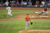 Houston Astros starting pitcher Justin Verlander (35) watches after giving up a home run to Texas Rangers' Nathaniel Lowe, left, during the fifth inning in Game 5 of the baseball American League Championship Series Friday, Oct. 20, 2023, in Arlington, Texas. (AP Photo/Tony Gutierrez)