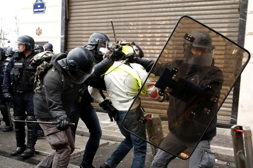 French police apprehend a protester wearing a yellow vest during a national day of protest by the “Yellow Jackets” movement in Paris on Dec. 8, 2018. (Photo: Christian Hartmann/Reuters)