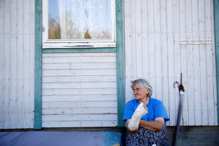 An internally displaced person sits outside a house at a reception center where IDPs live, in Bratunac, Bosnia and Herzegovina, September 28, 2018. REUTERS/Dado Ruvic