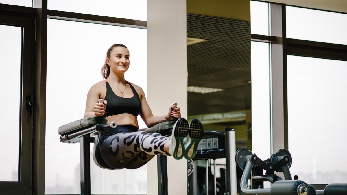 Asian woman with strong and muscular firm shape is training on leg day by  doing advance