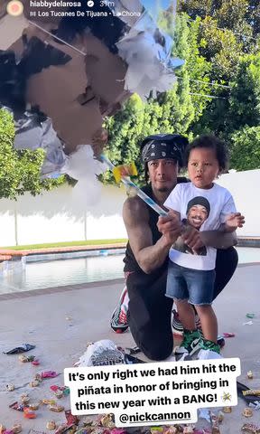 <p>Abby De La Rosa/ Instagram</p> Nick Cannon hits piñata with son