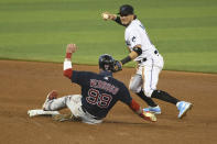 Miami Marlins shortstop Miguel Rojas throws to first after forcing out Boston Red Sox's Alex Verdugo at second during the sixth inning of a baseball game, Thursday, Sept. 17, 2020, in Miami. (AP Photo/Gaston De Cardenas)