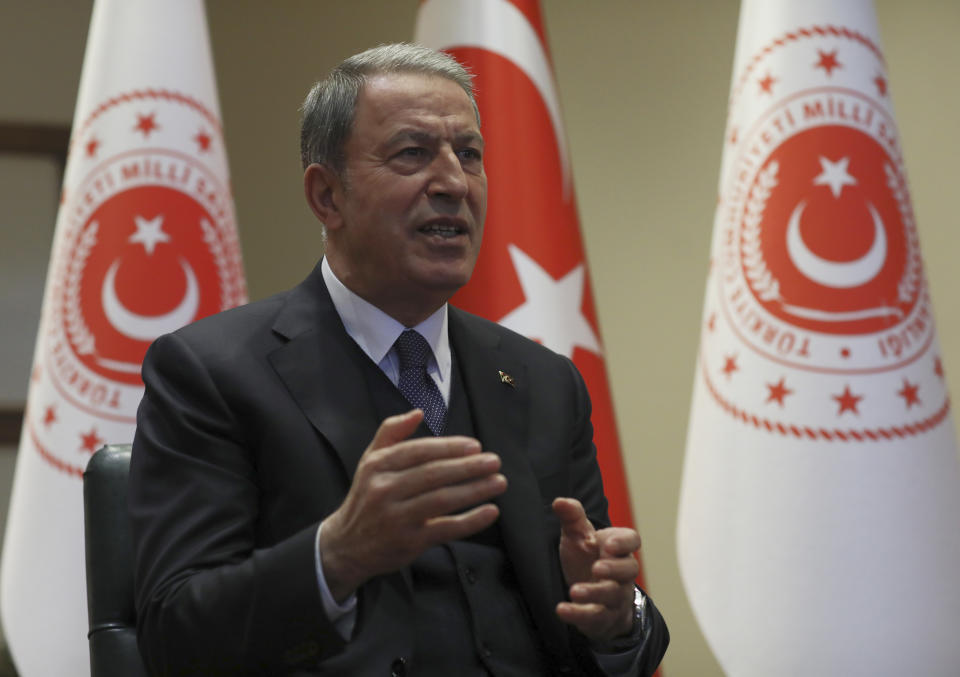 Turkey's Defense Minister Hulusi Akar speaks during an interview with the Associated Press, in Ankara, Turkey, Tuesday, Feb. 11, 2020. Akar said as many as four observation posts and two military positions are now in Syrian-controlled territory as the Syrian forces continued their advance into northwestern Idlib province, the last rebel stronghold and warned Turkish soldiers were under orders to retaliate forcefully to attacks on the military posts.(AP Photo/Burhan Ozbilici)
