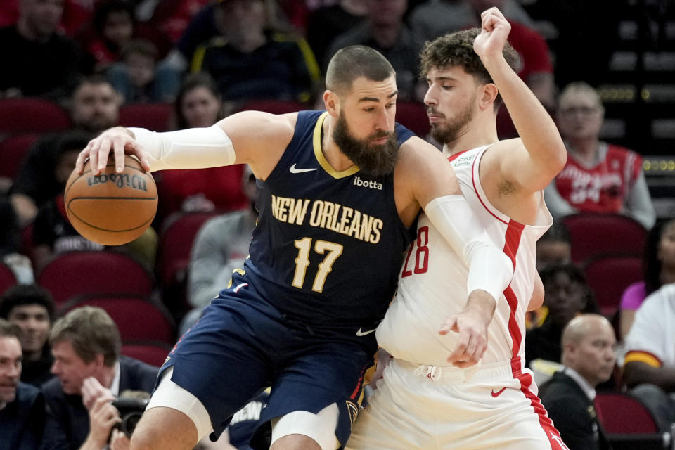 New Orleans Pelicans center Jonas Valanciunas (17) dribbles as Houston Rockets center Alperen Sengun defends during the first half of an NBA basketball game Wednesday, Jan. 31, 2024, in Houston. (AP Photo/Eric Christian Smith)