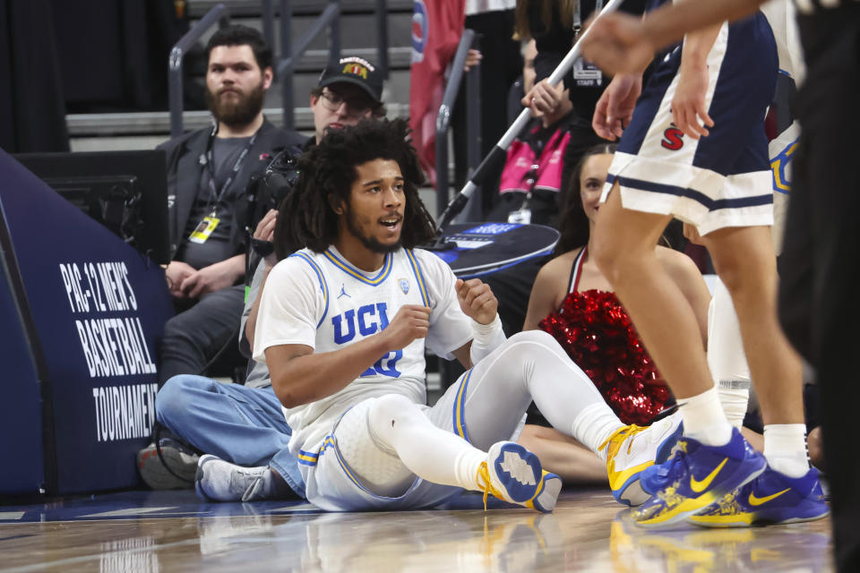 UCLA guard Tyger Campbell (10) reacts after drawing a foul on a shot against Arizona during the first half of an NCAA college basketball game in the championship of the Pac-12 tournament, Saturday, March 11, 2023, in Las Vegas. (AP Photo/Chase Stevens)