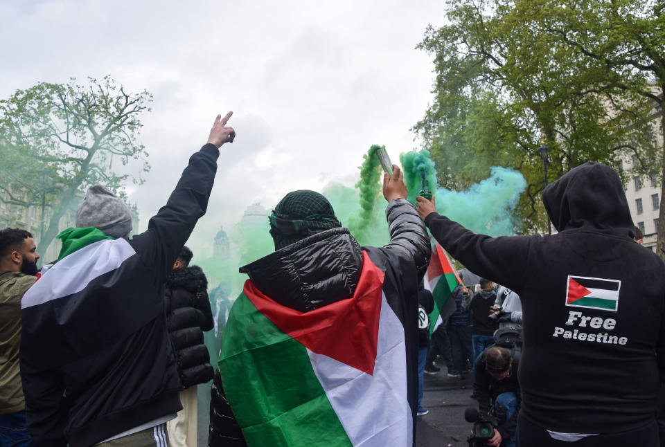 <p>LONDON, UNITED KINGDOM - 2021/05/16: Protesters hold up smoke flares outside Downing Street during the pro-Palestine demonstration. Protesters gathered in Central London for the second day of the weekend in support of Palestine as tensions between Israel and Palestine escalate. (Photo by Vuk Valcic/SOPA Images/LightRocket via Getty Images)</p>
