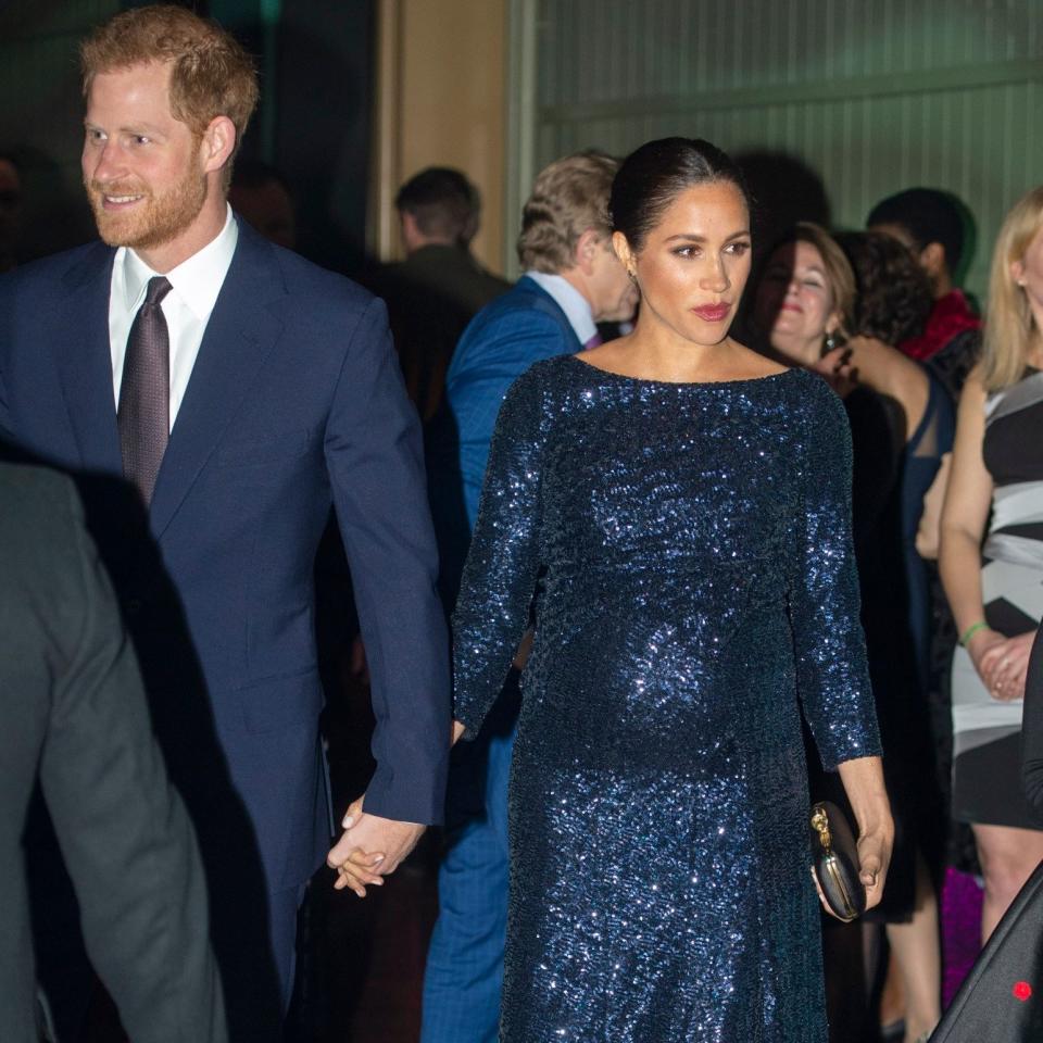 The Duke and Duchess of Sussex hold hands as they attend the event at the Royal Albert Hall - Paul Grover for the Telegraph