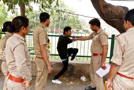 The "Anti-Romeo Squad" question a youth following regulations imposed by newly elected Uttar Pradesh State Chief Minister, Yogi Adityanath, in Lucknow, India, April 6, 2017. REUTERS/Cathal McNaughton