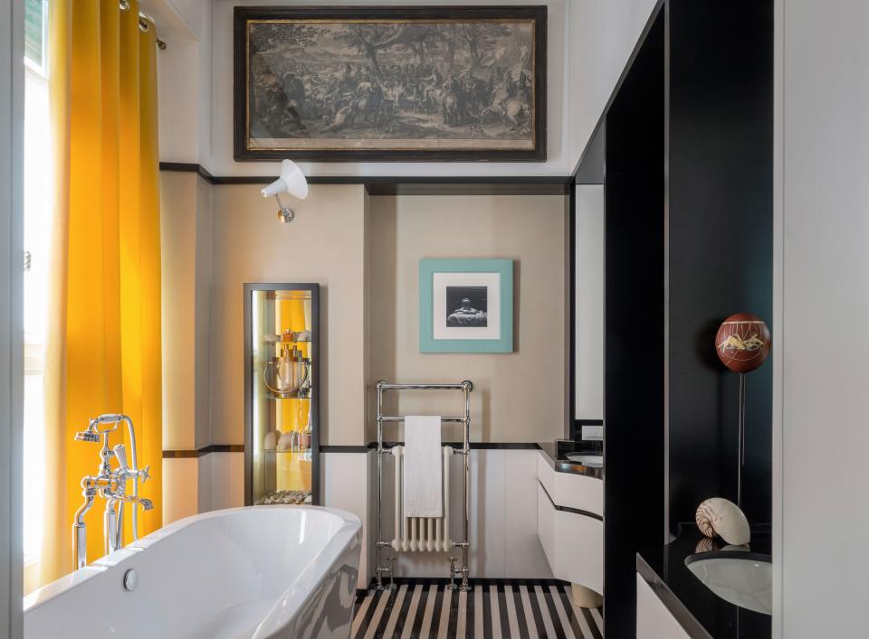 Salvagni designed the twin cabinets in the master bathroom, which is largely covered in black-and-white marble. The bathtub is from Duravit, and the fixtures are from Lefroy Brooks.