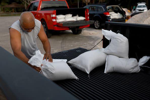 PINELLAS PARK, FLORIDA - AUGUST 29: Antonio Floyd places sandbags in a pickup truck at the Helen S. Howarth Community Park ahead of the possible arrival of Hurricane Idalia on August 29, 2023 in Pinellas Park, Florida. Hurricane Idalia is forecast to make landfall on the Gulf Coast of Florida on Wednesday morning. (Photo by Joe Raedle/Getty Images)