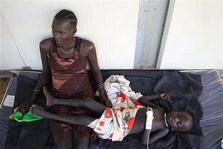 A displaced mother tends to her sick child at a United Nations hospital at Tomping camp, where some 15,000 displaced people who fled their homes are sheltered by the UN near South Sudan's capital Juba January 7, 2014. REUTERS/James Akena
