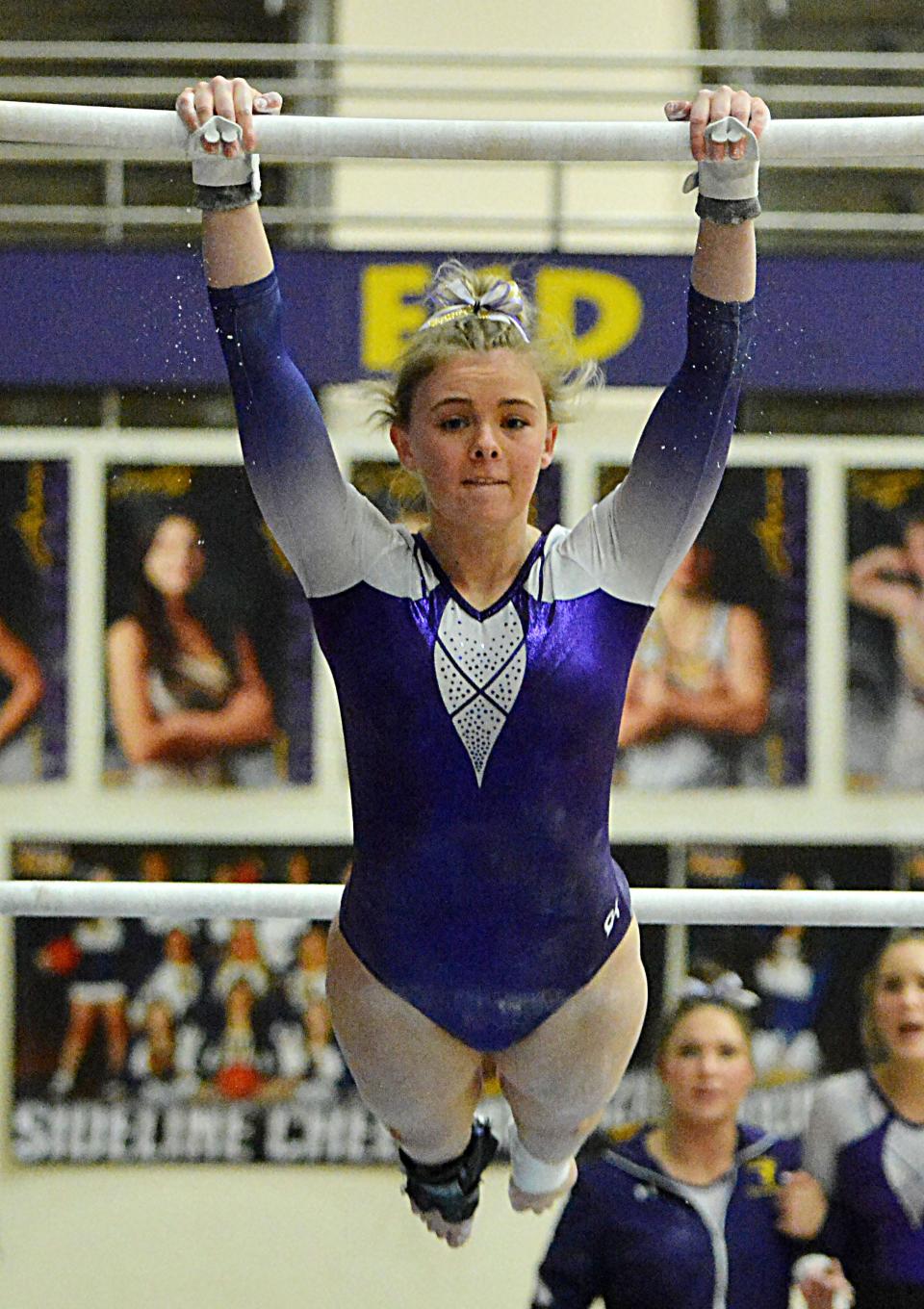 Watertown's Kinsley Van Gilder hangs on the uneven bars during a high school gymnastics triangular on Thursday, Jan. 25, 2024 in the Watertown Civic Arena.