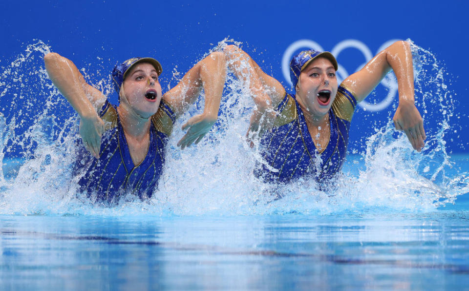 Two swimmers holding their arms at an awkward angle