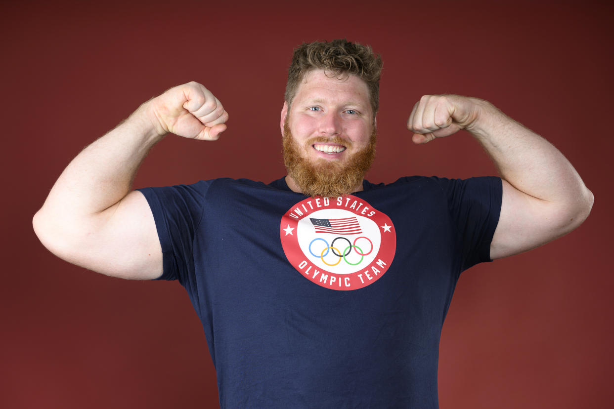 Olympian Ryan Crouser with arms raised.