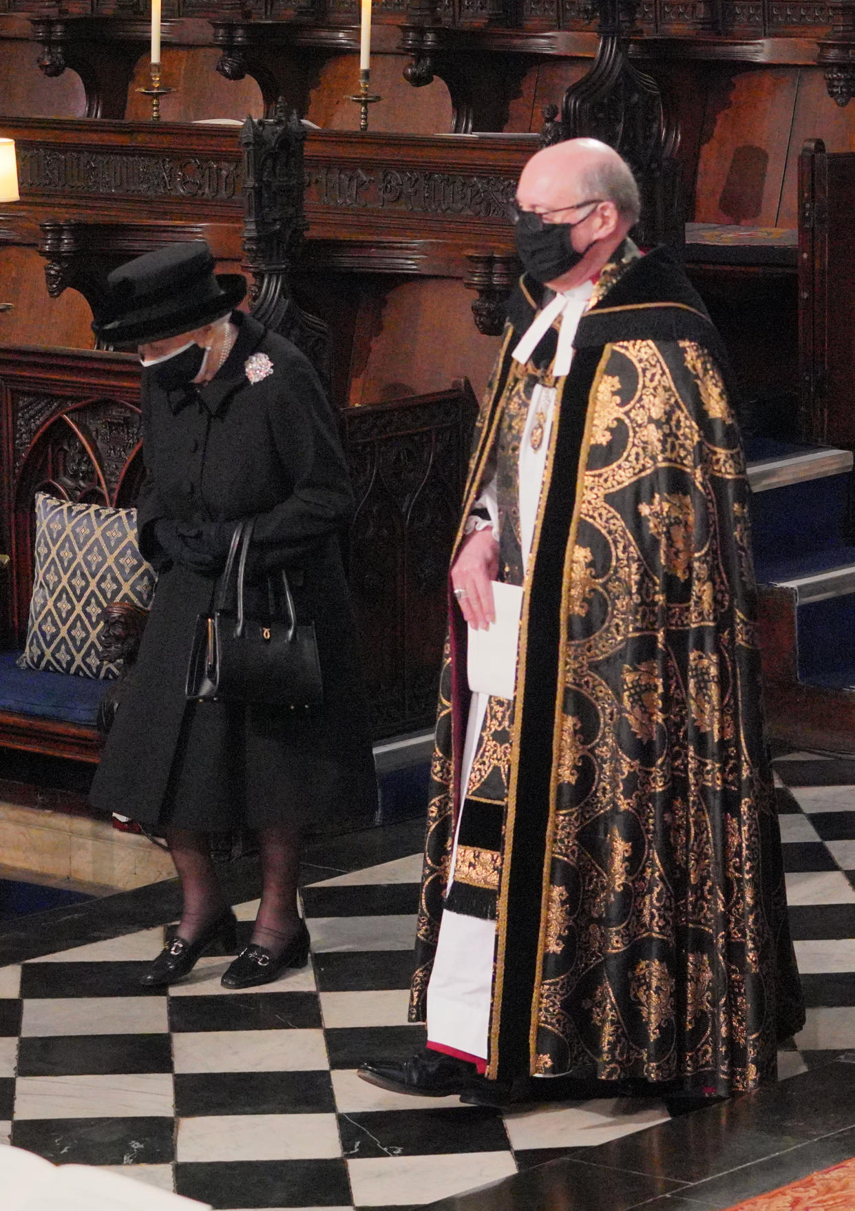 Queen Elizabeth II is conducted by the Dean of Windsor into the Quire of St George's Chapel in Windsor Castle, Berkshire, for the funeral of the Duke of Edinburgh. Picture date: Saturday April 17, 2021.