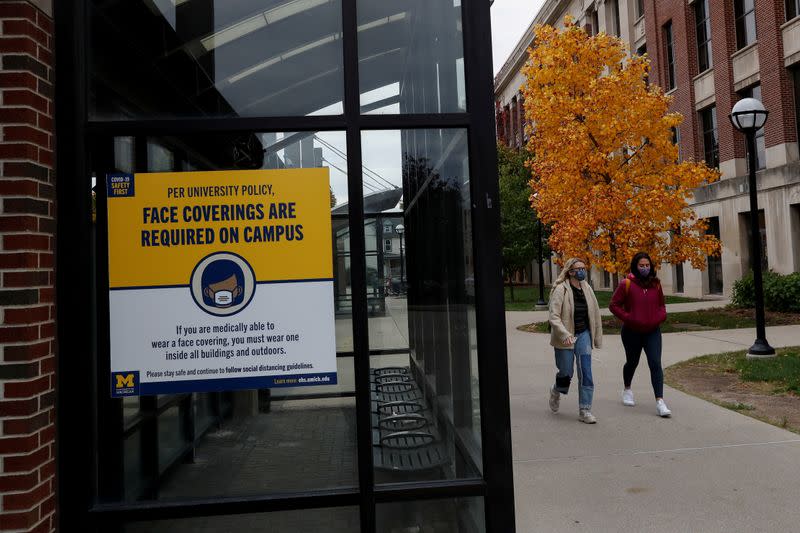 FILE PHOTO: Women with protective face masks walk on the University of Michigan campus in Ann Arbor