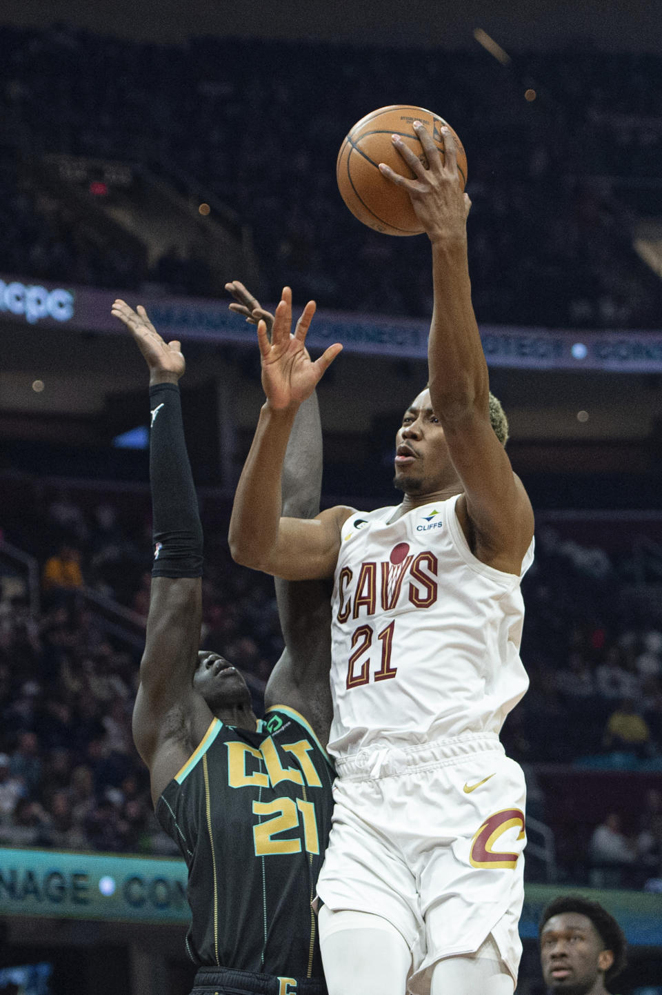 Cleveland Cavaliers' Mamadi Diakite (21) shoots as Charlotte Hornets' JT Thor (21) defends during the first half of an NBA basketball game in Cleveland, Sunday, April 9, 2023. (AP Photo/Phil Long)