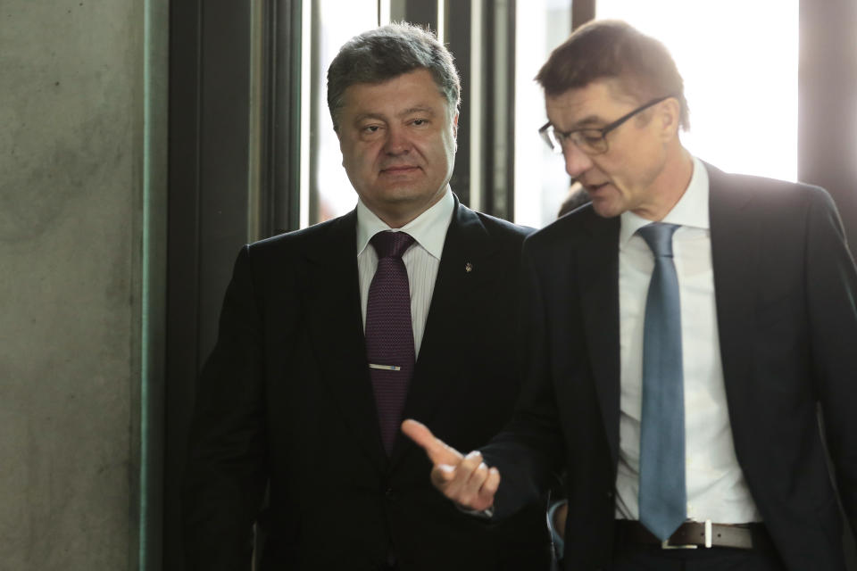 Ukrainian presidential candidate and businessman Petro Poroshenko, left, is accompanied by Germany's Christian Union's ruling party deputy faction leader Andreas Schockenhoff prior to a meeting in Berlin, Germany, Wednesday, May 7, 2014. The Ukrainian government is planing a presidential election on May 25, 2014. (AP Photo/Markus Schreiber)