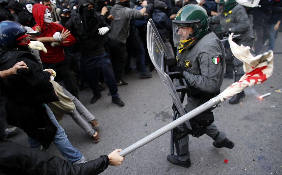 A protester clashes with a Guardia di Finanza policeman in front of the Ministry of Finance building in downtown Rome