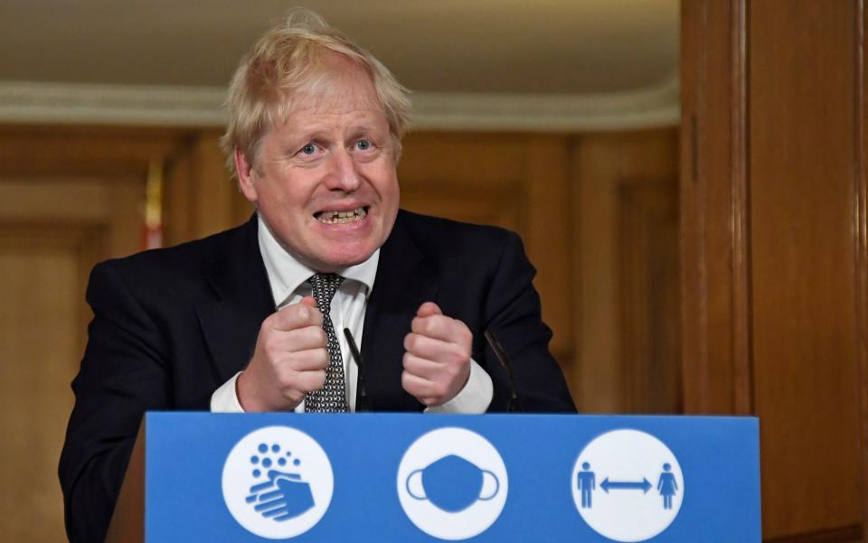 Prime Minister Boris Johnson gestures as he speaks during a coronavirus press conference at 10 Downing Street - Alberto Pezzali/AP