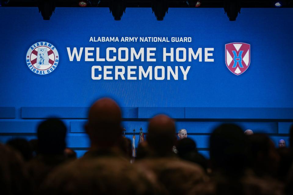 A large ‘Welcome Home’ projection greets Alabama Army National Guard soldiers from the 135th Expeditionary Sustainment Command at a return home ceremony in Birmingham, Ala., January 14, 2023. Soldiers were returning from a year-long mobilization to Kuwait in support of the U.S. Central Command.