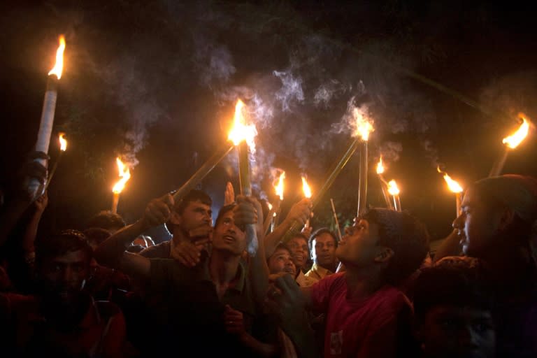 Former Indian enclave residents carry lit torches during a procession at Dasiarchhara, Kurigram in Bangladesh on August 1, 2015