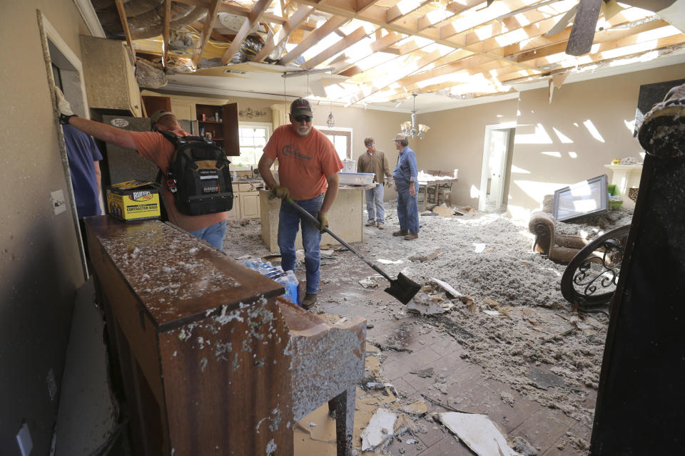 Friends and family descend on the home of Suzanne Harlow in Pontotoc, Miss., Saturday, April 1, 2023 along Rosalee Drive to help her recover some of her belongings following an early morning tornado that rolled through much of Northeast Mississippi.(Thomas Wells/The Northeast Mississippi Daily Journal via AP)