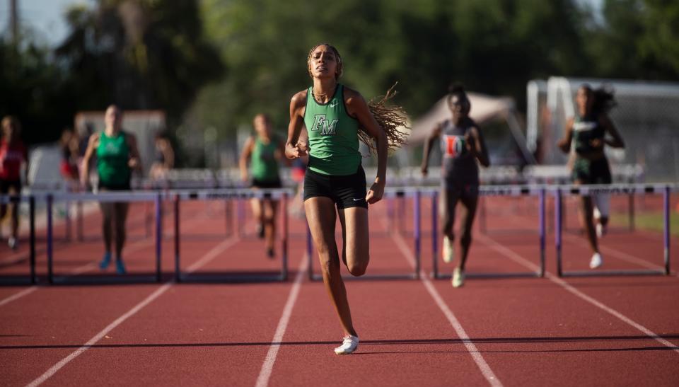 Joelle White of Fort Myers High School wins the girls 400 hurdles during the LCAC Track and Field Championships at Cypress Lake High School on Wednesday, April 17, 2024.