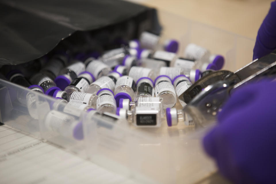 FILE - This Tuesday Dec. 8, 2020 file photo shows Pfizer-BioNTech COVID-19 vaccine bottles at Southmead Hospital in Bristol, England, as the mass public vaccination program gets underway. Britain races to vaccinate more than 15 million people by mid-February, and in an effort to ensure vaccines get to the right places at the right times, along with the syringes, alcohol swabs and protective equipment needed to administer them, the government has called in the army. (Graeme Robertson/Pool via AP, File)