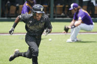 Vanderbilt's Javier Vaz, left, runs to first base to beat out a bunt single as East Carolina pitcher Gavin Williams, right, fields the ball in the seventh inning of an NCAA college baseball super regional game Friday, June 11, 2021, in Nashville, Tenn. Vanderbilt won 2-0. (AP Photo/Mark Humphrey)