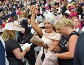 Britain Horse Racing - Royal Ascot - Ascot Racecourse - 16/6/16 Ladies Day Racegoers celebrate winner Reuters / Toby Melville