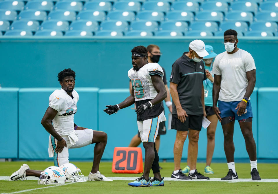 MIAMI GARDENS, FLORIDA - AUGUST 29: (L-R) Stephen M. Ross Chairman of the Board & Managing General Partner of the Miami Dolphins speaks with DeVante Parker #11 of the Miami Dolphins as Isaiah Ford #84 and Jakeem Grant #19 of the Miami Dolphins get ready for training camp at Hard Rock Stadium on August 29, 2020 in Miami Gardens, Florida. (Photo by Mark Brown/Getty Images)