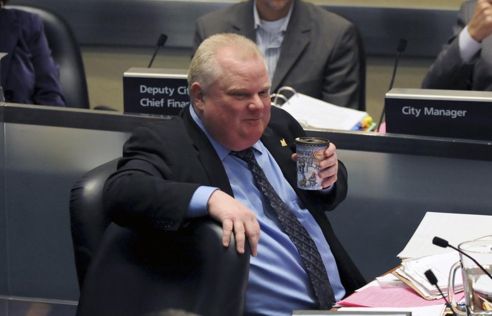 Toronto Mayor Rob Ford sips a cup of coffee during a city council meeting in Toronto