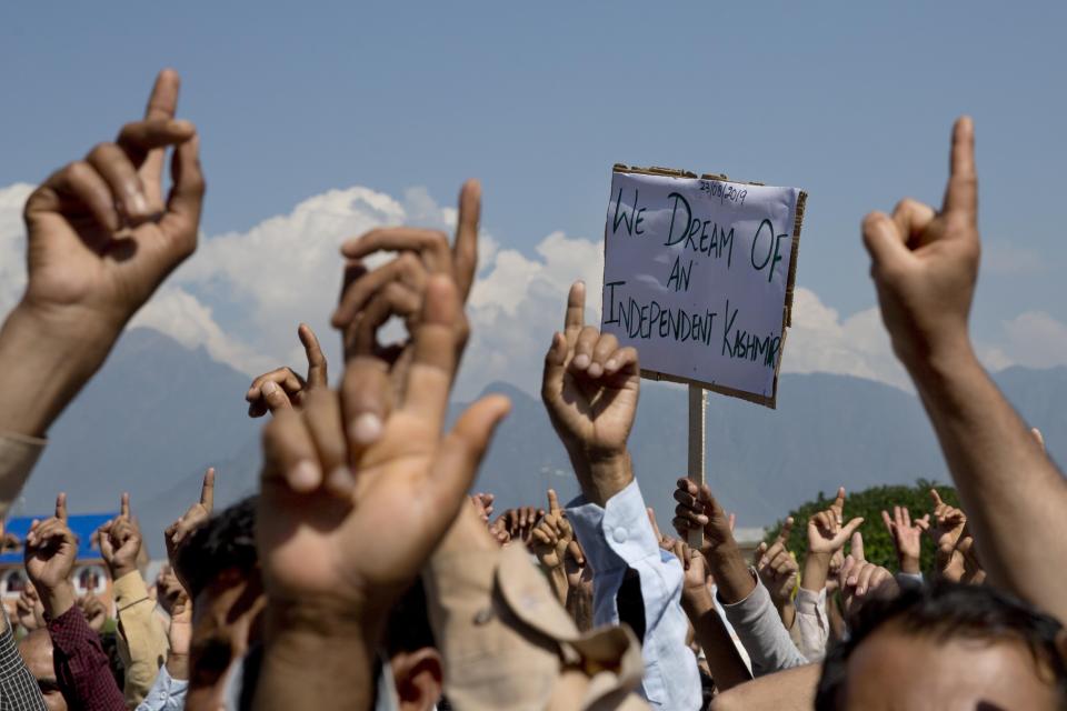FILE - In this Friday, Aug. 23, 2019, file photo, Kashmiri men shout freedom slogans during a protest against New Delhi's tightened grip on the disputed region, after Friday prayers on the outskirts of Srinagar, Indian controlled Kashmir. India’s Home Minister Amit Shah says normalcy has returned in most areas in Indian-controlled Kashmir but the detention of politicians and the blockade of the internet and social media are continuing because of security concerns. Asked by lawmakers in Parliament on Wednesday, Nov. 20, how soon the restrictions are likely to be lifted, Shah says authorities have to fix priorities when it comes to security and the fight against terrorism. India stripped the region of its semi-autonomous powers and implemented a strict clampdown on Aug. 5. (AP Photo/ Dar Yasin, File)